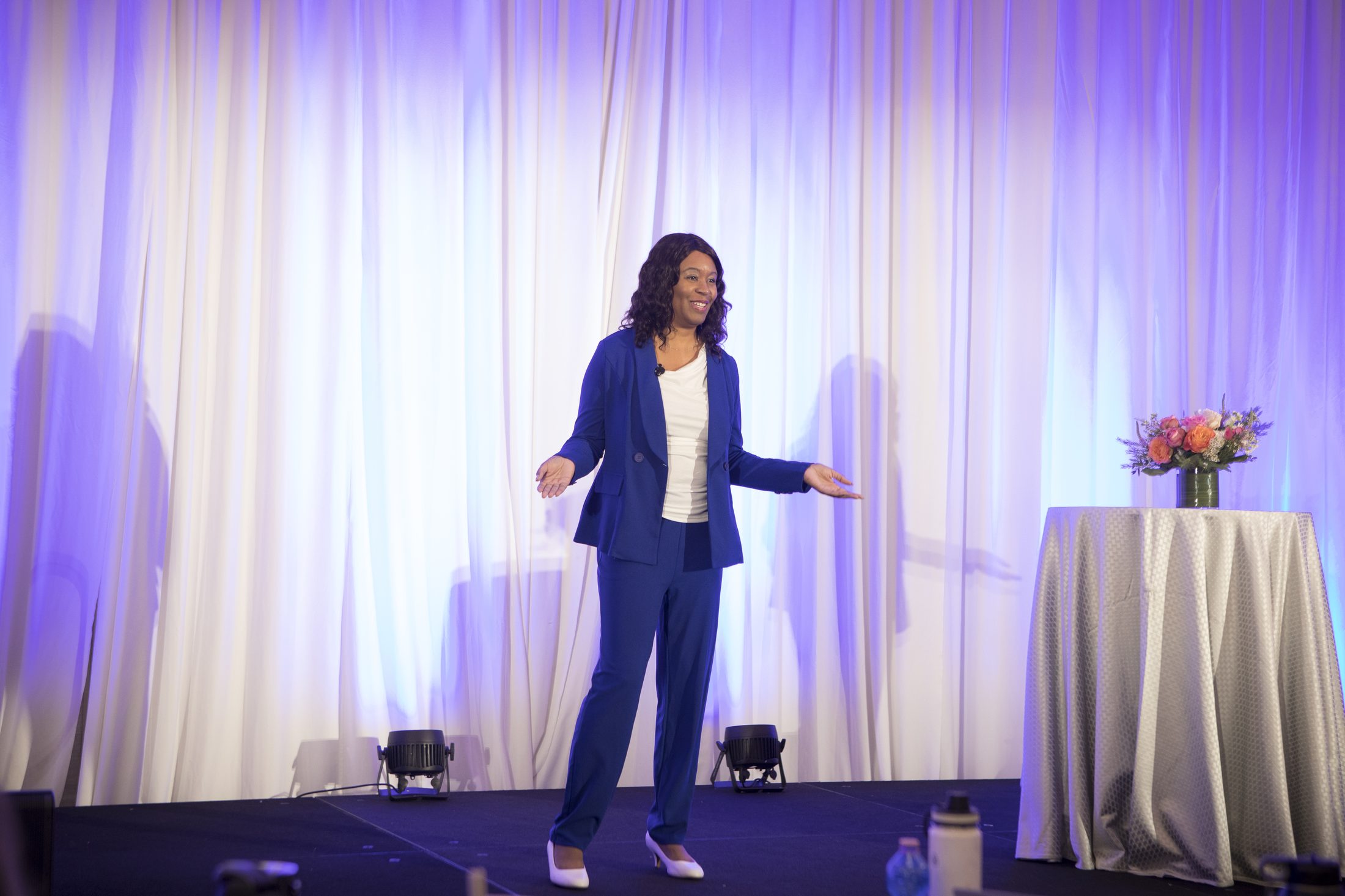 Alexis King speaking on a lit conference stage